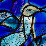Detail of a bird in the window in the north wall of the chancel