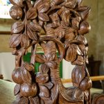 Choir stall poppy head depicting a squirrel in a tree